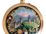 a gold pocket watch with a picture of a castle on it