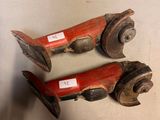 pair of antique cast iron fire extinguisors with red paint