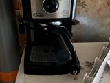 a coffee maker sitting on top of a counter next to a microwave