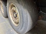 a close up view of a flat tire on a truck