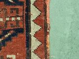a close up of a rug with a cat laying on top of it