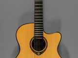 an acoustic guitar on a stand against a gray background