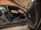 a car that is parked in a garage with its door open