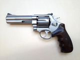 a close up of a revolver on a table with a white background