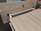 a bed with a wooden headboard and a drawer underneath it