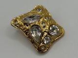 an image of a close up of a gold and diamond broochle