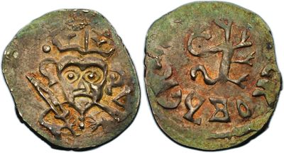 two ancient coins with symbols on them, one of which is a lion and the other of which is a