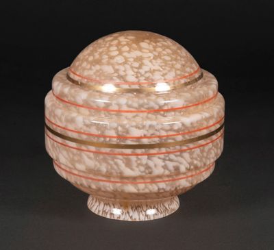 a close up of a glass bowl with a lid on a black surface
