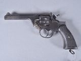 a gun that is sitting on a white surface