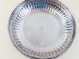 a silver plate on a table with a white background