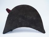 a black hat with red horns on it on a white surface