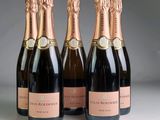 three bottles of champagne are lined up on a table