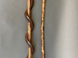 two wooden walking canes sitting on top of a table