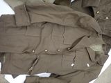 a brown jacket sitting on top of a white table