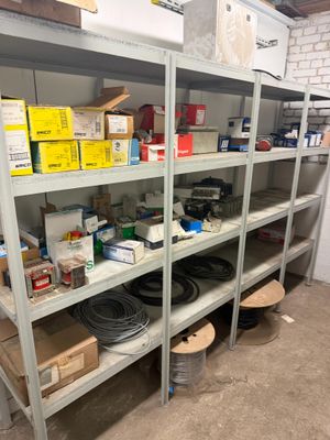 many shelves with various items on them in a room