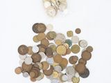 a pile of coins sitting on a white surface