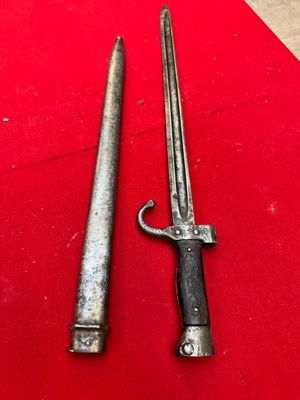 two old swords are sitting on a red surface