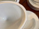 a lot of plates and bowls on the table