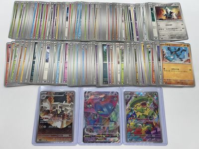 a lot of different pokemon cards on the table