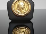 a close up of a gold medal with a woman ' s face on it