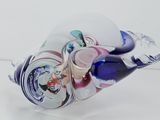 a glass vase with a glass animal inside of it