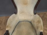 an old fashioned chair sitting on top of a wooden floor