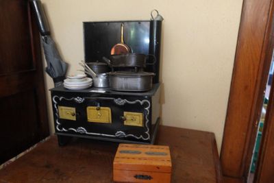 a small stove with pots and pans on top of it