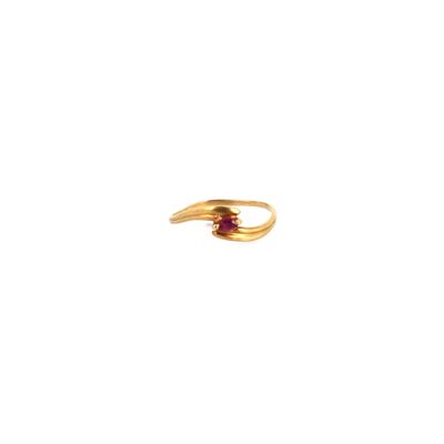 a close up of a gold ring with a red stone