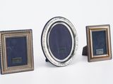 three picture frames sitting next to each other on a white surface