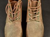 pair of brown boots with laces on them on a black surface