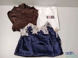 two shirts and a skirt are sitting on a table