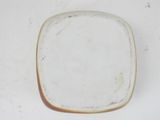 a white plate with a brown rim sitting on a table