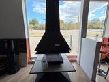 a fireplace in the middle of a living room with a view of the street