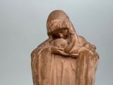 a statue of a woman holding a baby in her arms