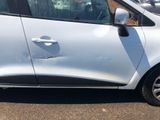 a small white car parked on the side of the road