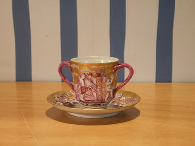 a cup and saucer sitting on a wooden table