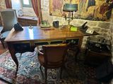 a desk with a chair and a lamp in a room