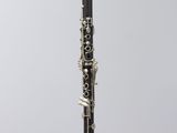 a close up of a clarinet on a stand against a white background