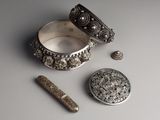 a silver box with a silver object next to it on a table
