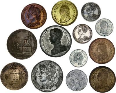 a close up of a bunch of coins on a white surface