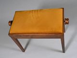 a small wooden stool with a yellow seat on it