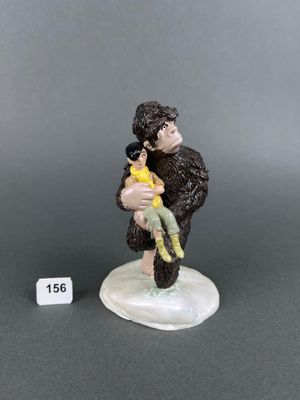 a close up of a figurine of a man holding a child
