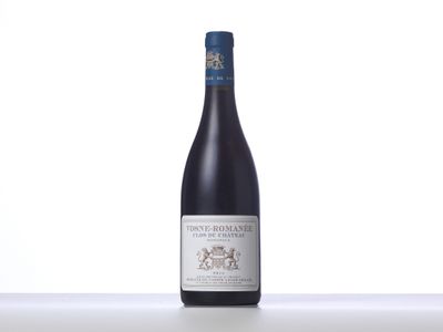 a bottle of red wine sitting on top of a table