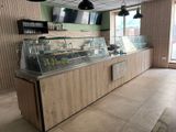 a picture of a restaurant with a counter and a television