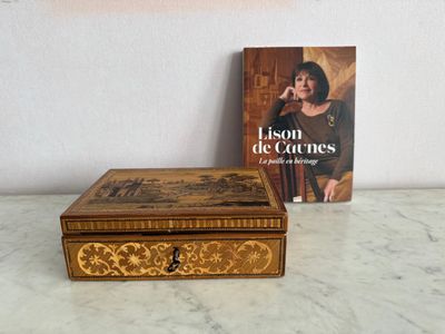 a book sitting next to a box on a table
