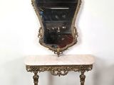 an ornately decorated table with a mirror on top of it