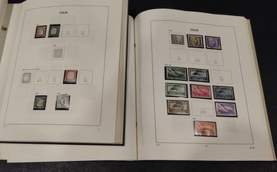 two open books with stamps on them on a table