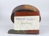 a small wooden box with a note attached to it