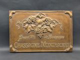 a close up of a plaque with a bunch of grapes on it
