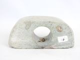 a stone sculpture with a hole in the middle of it
